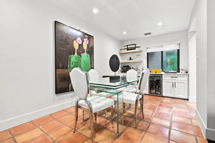 Dining area featuring terracotta tile flooring and recessed lighting