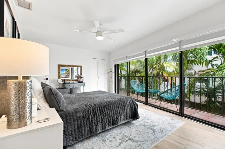 Bedroom featuring wood-finish flooring and a ceiling fan with integrated lighting