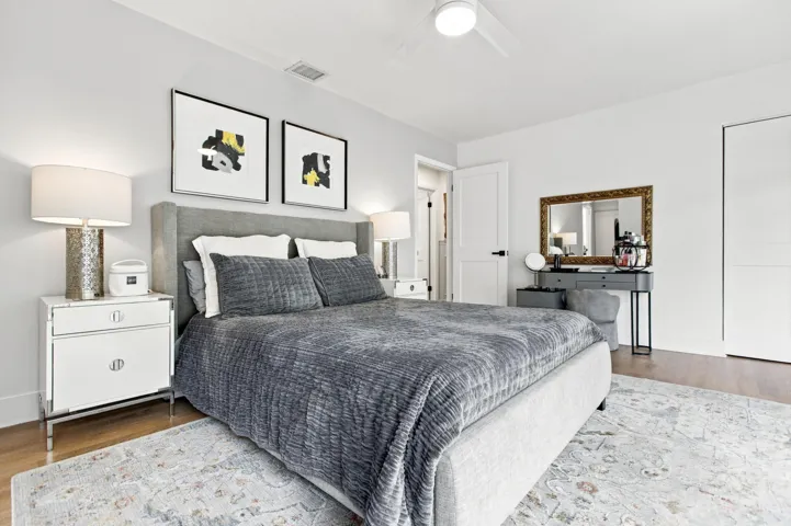 Bedroom featuring wood-finish flooring, a contemporary ceiling fan, recessed lighting, and a white paneled door