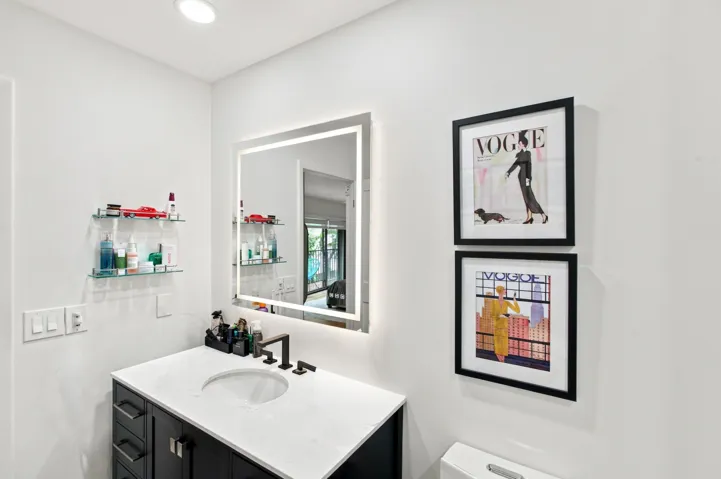 Contemporary bathroom featuring a vanity with a white countertop, an undermount sink, and a matte black faucet
