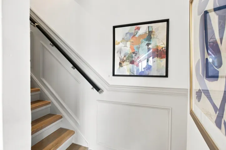 Staircase with natural wood treads and white risers