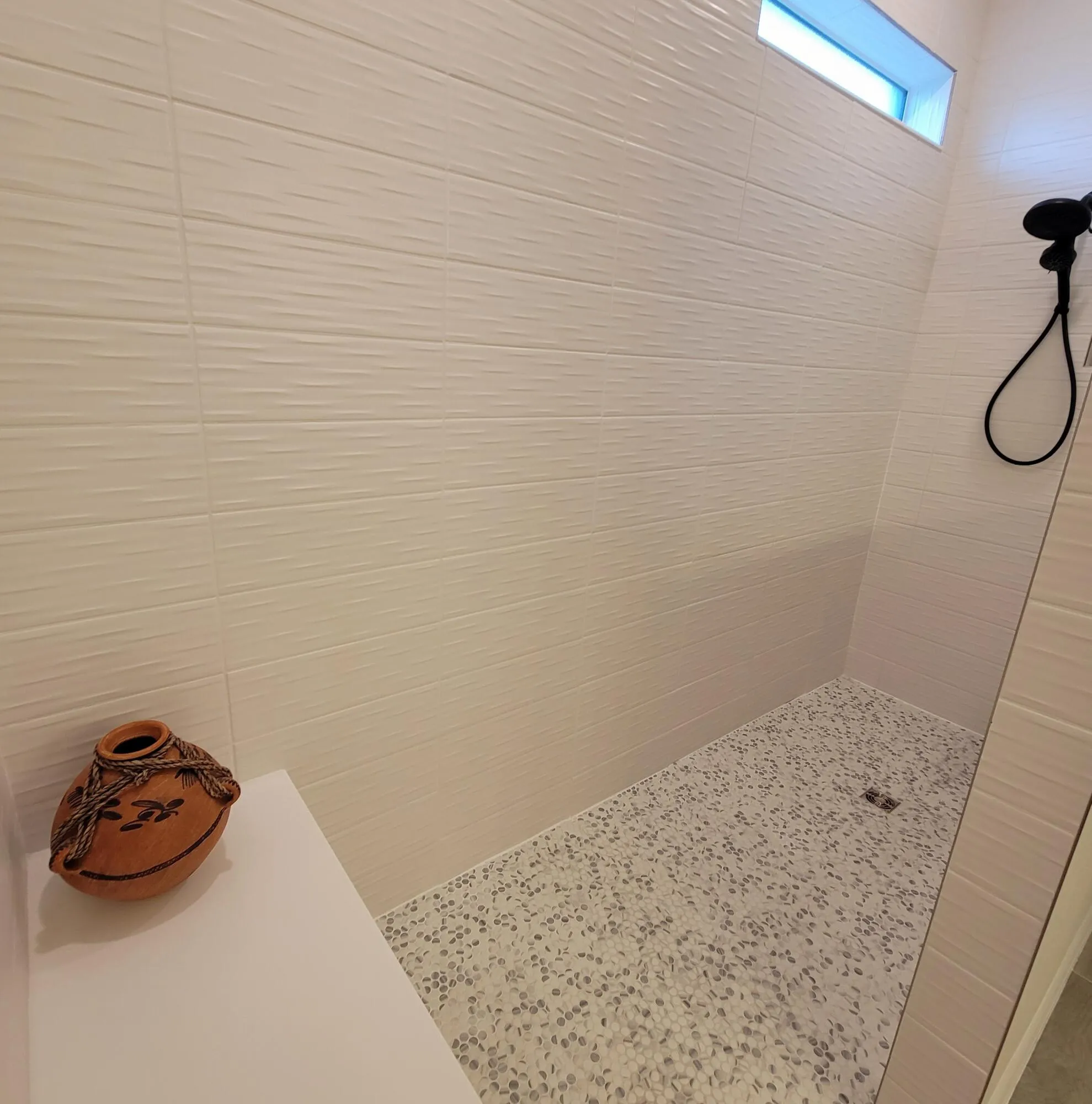 OVERSIZED DEEP WALK IN SHOWER WITH BENCH AND CLEAR HALF WALL PARTITION