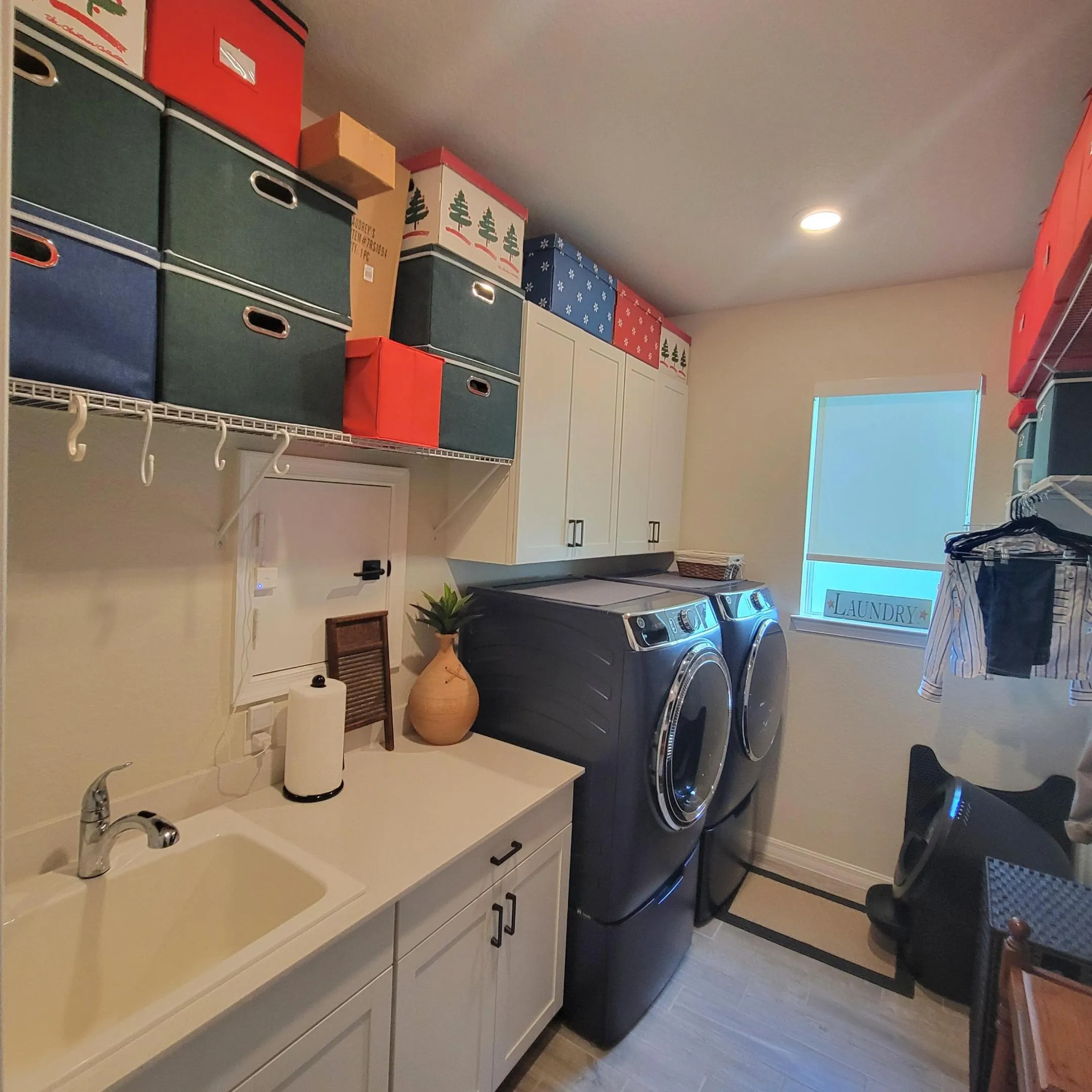 FULL SIZE FRONT LOAD WASHER & GAS DRYER ON RISERS WITH SINK AND LAUNDRY PASS THRU DOOR
