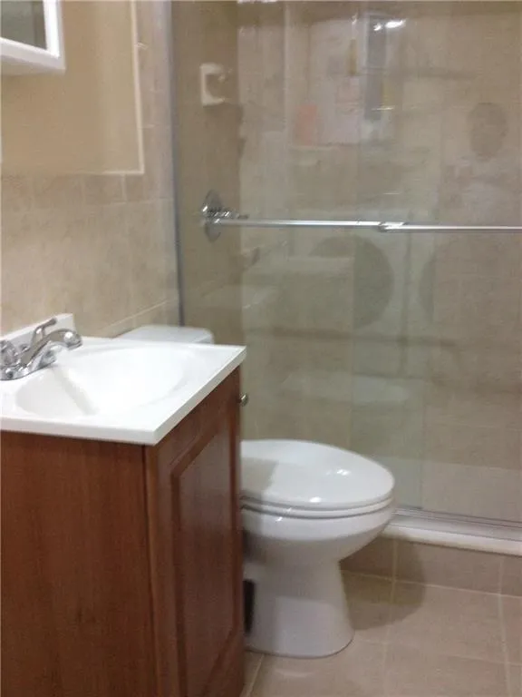 Bathroom featuring a wood-finish vanity with an integrated sink, polished chrome faucet, and a wall-mounted medicine cabinet