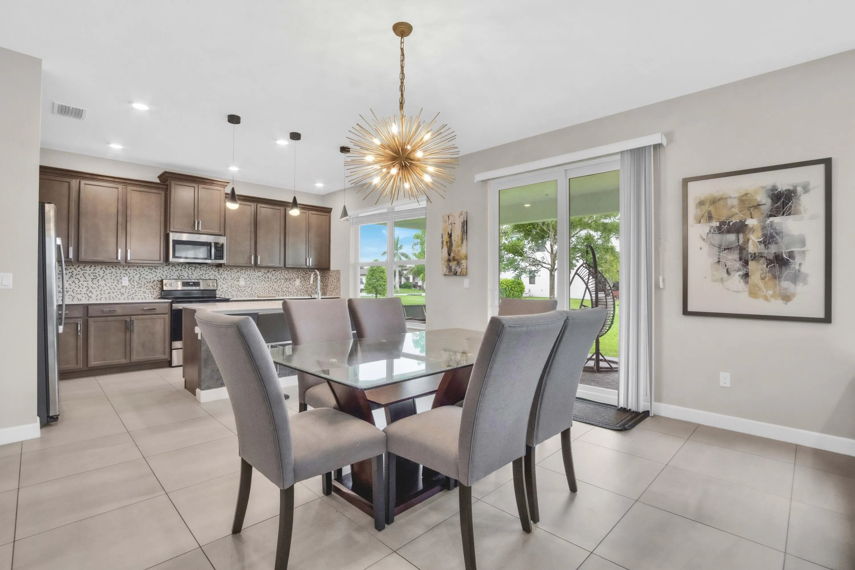 The open kitchen and breakfast area create the perfect everyday gathering spot, with sliding glass doors that lead directly to the backyard.