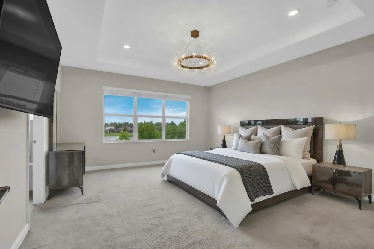 Retreat to the spacious primary suite, complete with its own tray ceiling and beautiful water views.