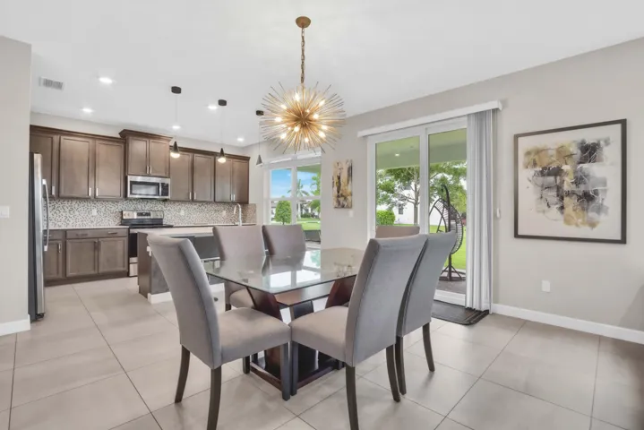 The open kitchen and breakfast area create the perfect everyday gathering spot, with sliding glass doors that lead directly to the backyard.