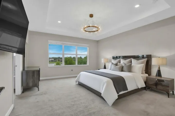 Retreat to the spacious primary suite, complete with its own tray ceiling and beautiful water views.