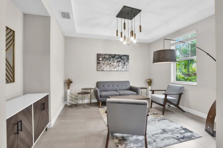 Just off the entry, the formal dining room features a dramatic tray ceiling and a modern statement light fixture, setting an elegant tone for dinner parties or quiet evenings.