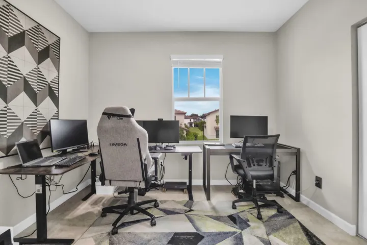 Currently set up as a productive home office with multiple workstations, this room easily converts back to a bedroom when needed.