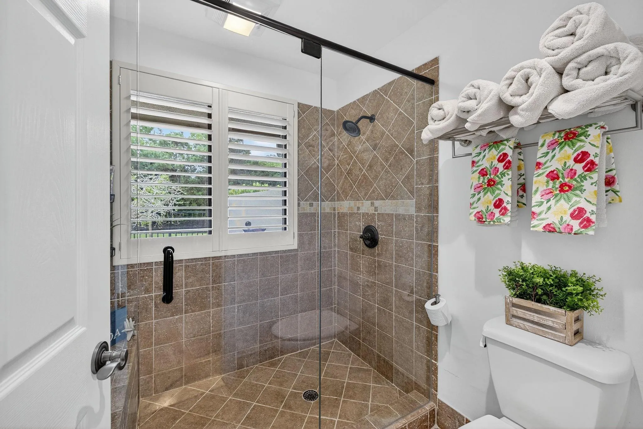 Oversized primary shower with lake views.