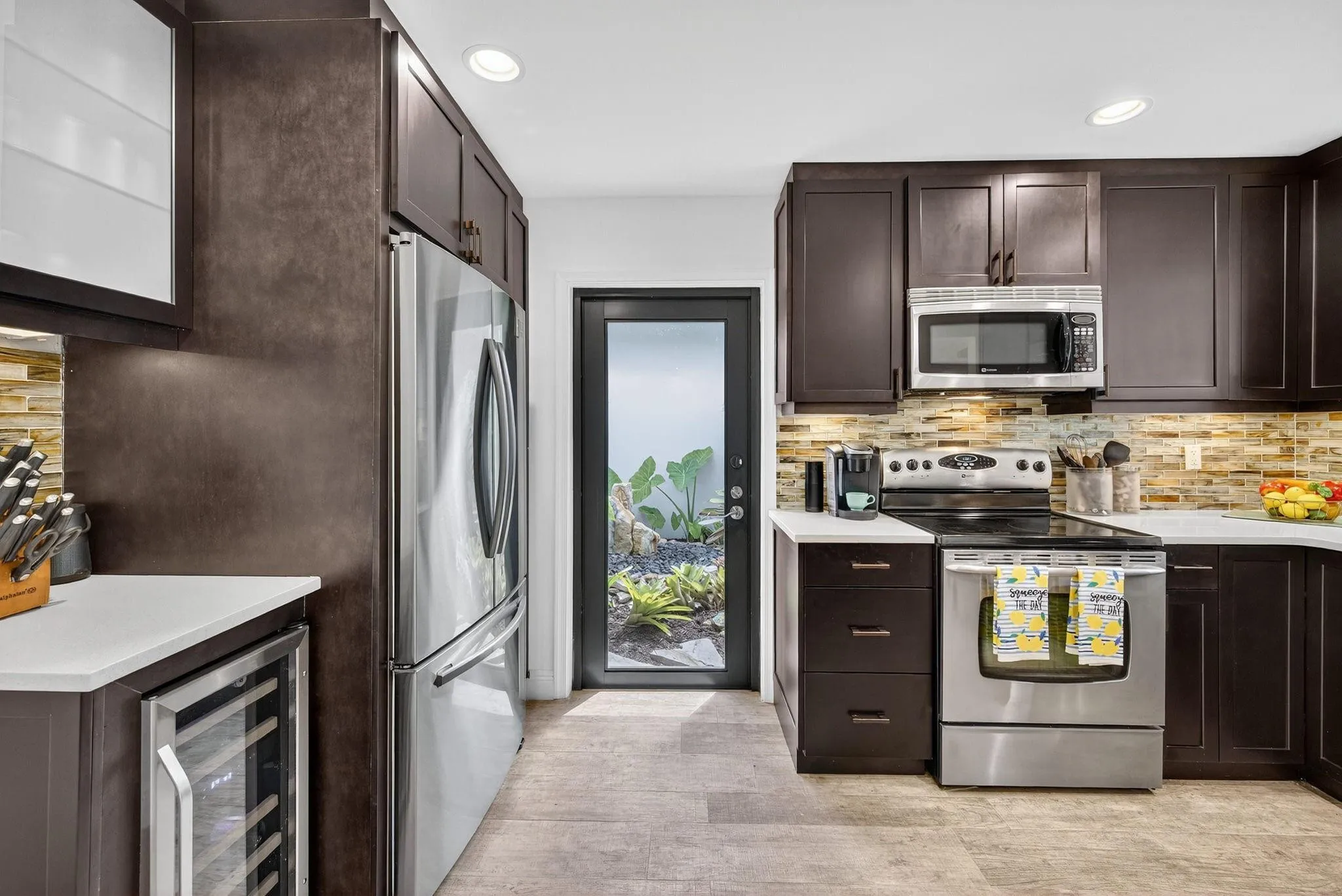 Kitchen view with door to the gorgeous gardens with waterfall.
