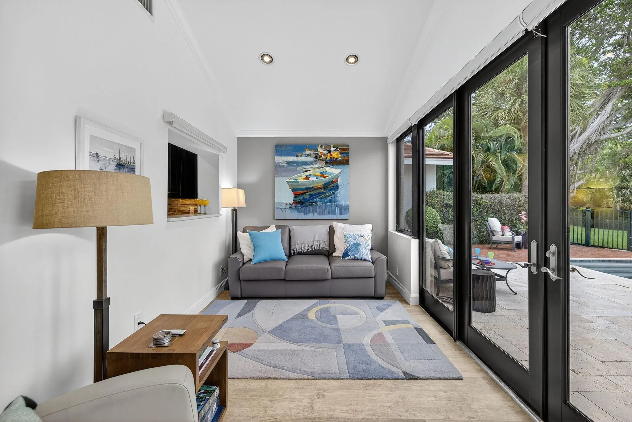 Florida room with wall to wall windows and doors.