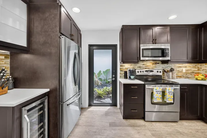 Kitchen view with door to the gorgeous gardens with waterfall.