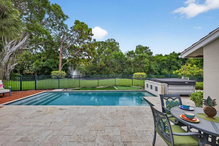 Sparkling pool, spa, lake, fountain and park views.