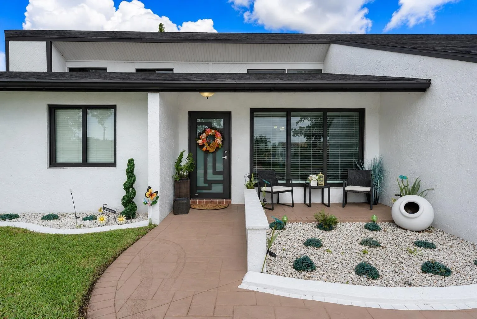 Contemporary exterior with white stucco finish and contrasting dark trim