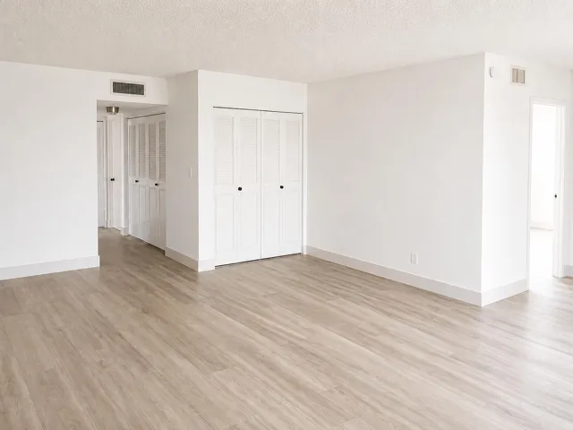 Light wood-finish flooring throughout, complemented by white walls and baseboards