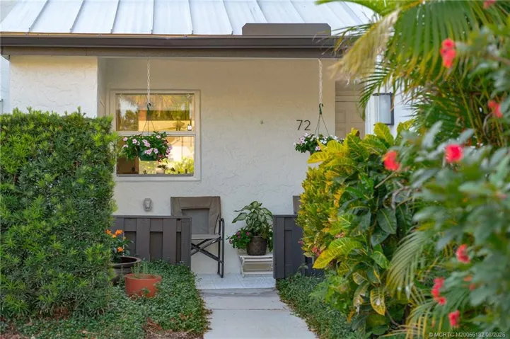 Flowers enhance the walkway to the front door