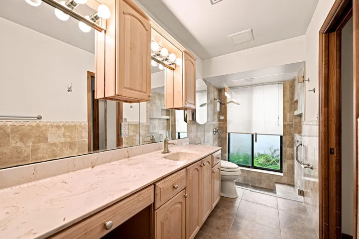 UPGRADED MASTER BATH. MARBLE COUNTER. MANY CABINETS AND DRAWERS. CUSTOM SHOWER. BIG MIRRORS.