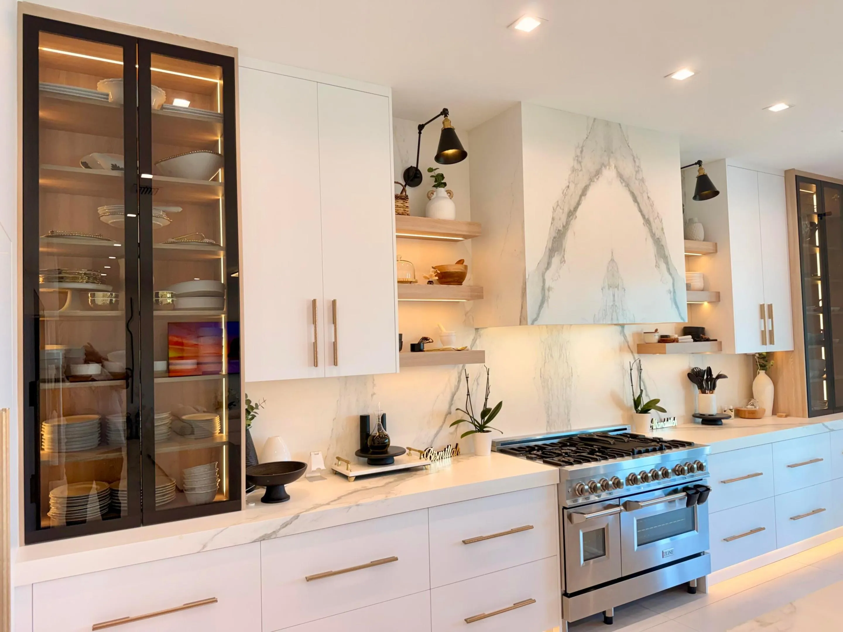High-end appliance package with custom cabinetry, porcelain slab backsplash, and thoughtful lighting details.
