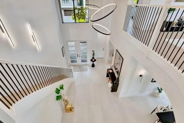 Upper-level perspective showcasing the scale and openness of the entryway below.