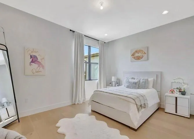 Generously sized bedroom with neutral finishes, abundant natural light, and flexible space for guests or family.