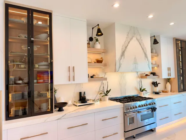 High-end appliance package with custom cabinetry, porcelain slab backsplash, and thoughtful lighting details.
