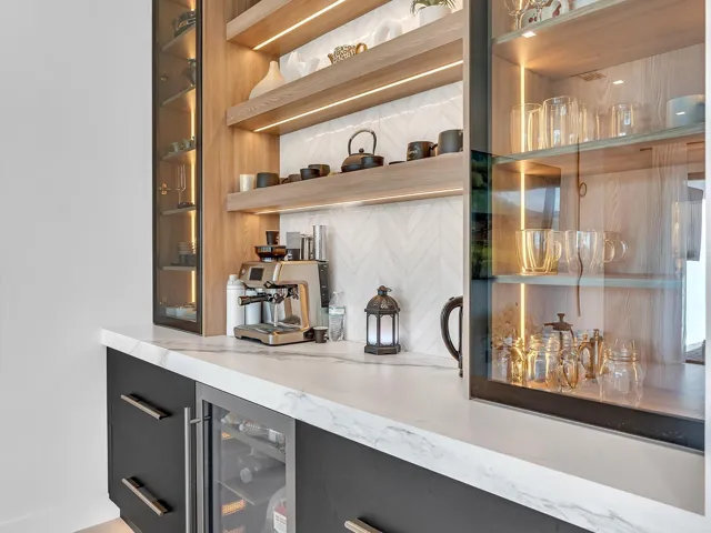 Custom built-in bar featuring integrated refrigeration, accent lighting, and display shelving—ideal for entertaining.