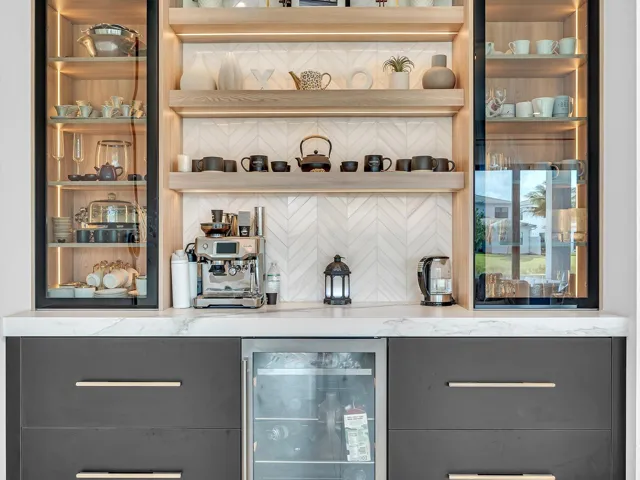 Custom built-in bar featuring integrated refrigeration, accent lighting, and display shelving—ideal for entertaining.