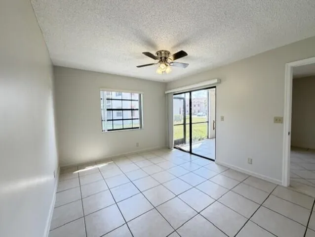 PRIMARY BEDROOM THAT OPENS TO PATIO AND VIEW OF LAKE