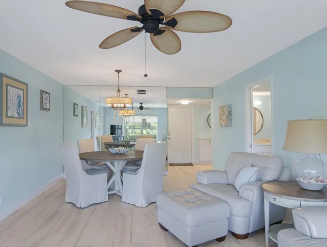 Bright interior featuring light wood-look ceramic tile flooring and a light blue wall color