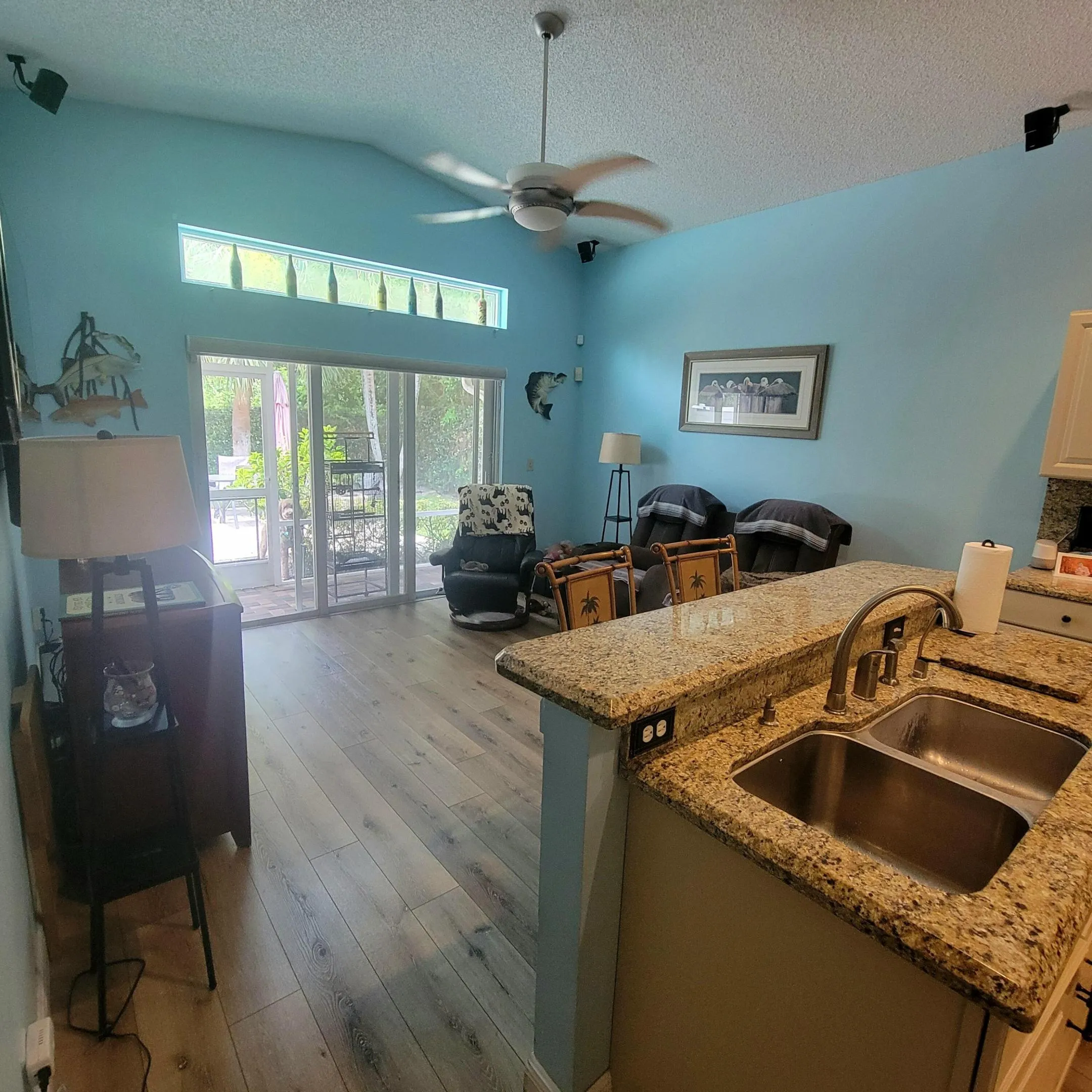 OPENS TO SCREENED COVERED PATIO WITH A GARDEN VIEW