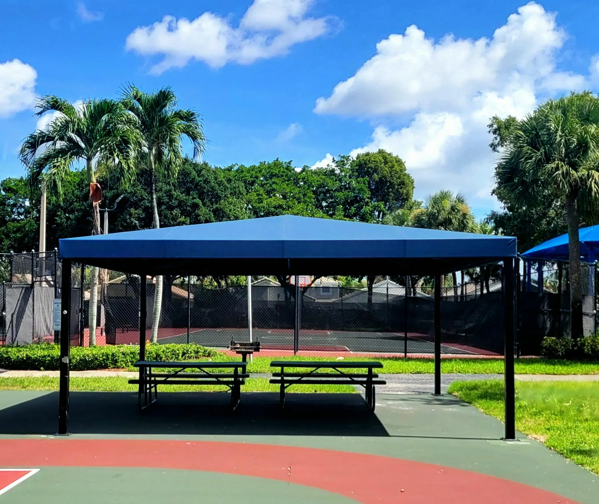 PLENTY OF SHADE PROTECTION & A CHARCOAL GRILL AVAILABLE