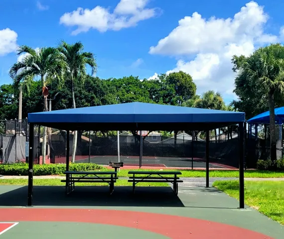 PLENTY OF SHADE PROTECTION & A CHARCOAL GRILL AVAILABLE