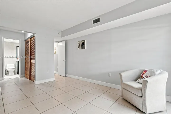 Bedroom or flex space with tile flooring, access to an ensuite bathroom, and closet storage.Do you have more photos for this listing, or is this the full set?