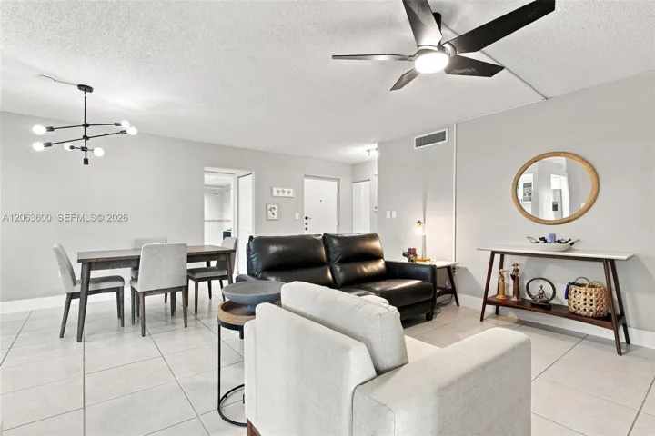 Open living and dining space with tile flooring