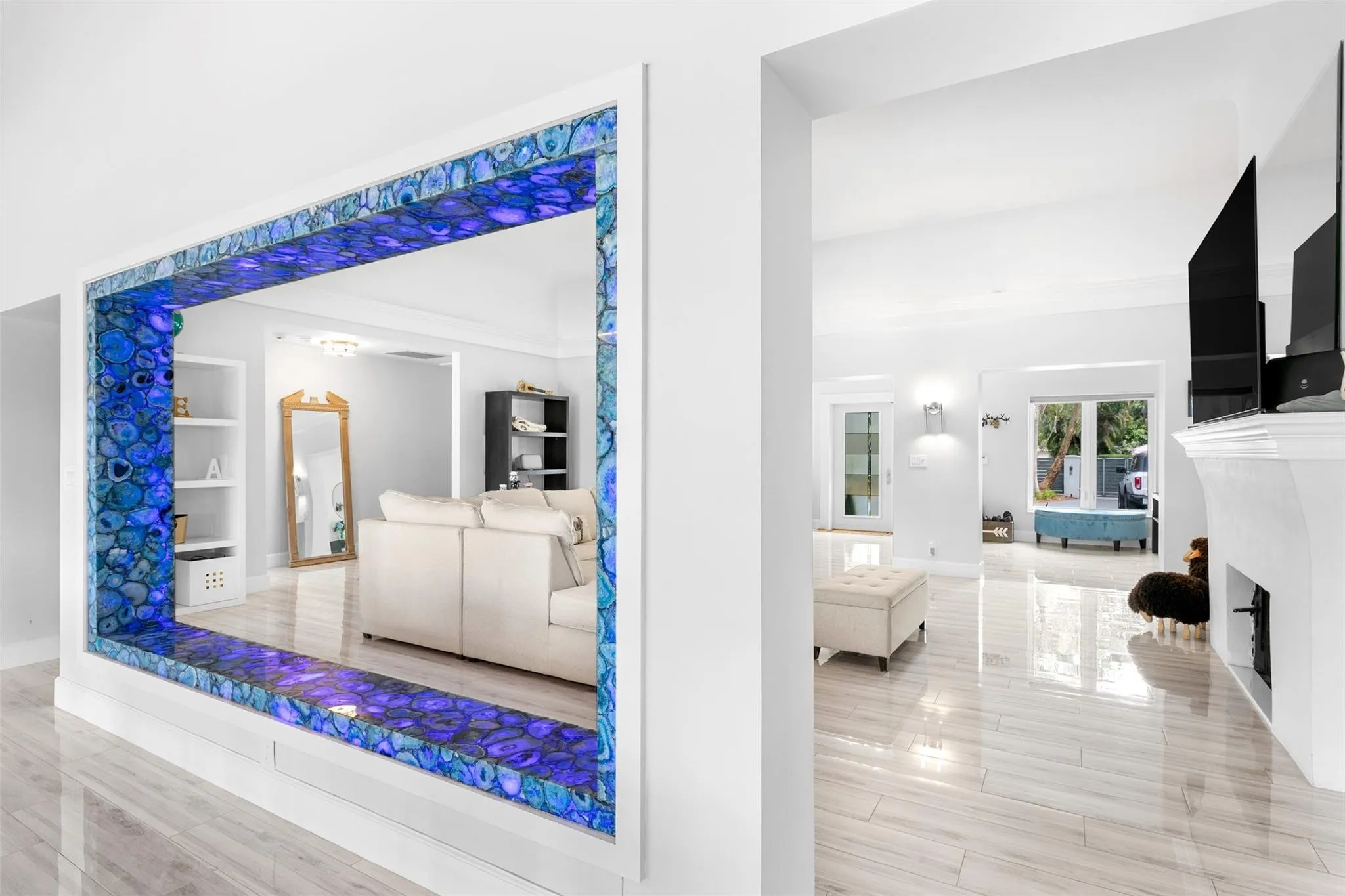 Open-concept interior featuring a distinctive pass-through window with illuminated blue agate surround