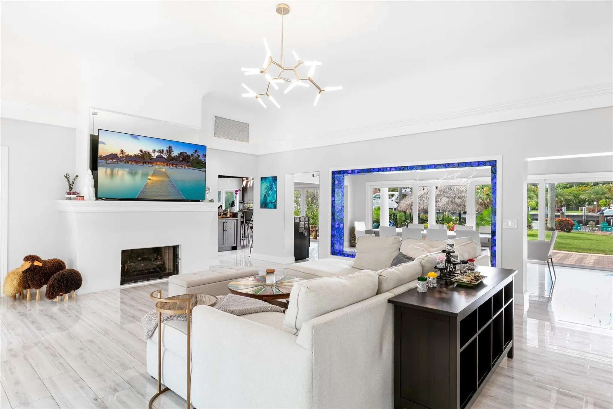 Expansive living area with high ceilings, recessed lighting, and wood-finish flooring
