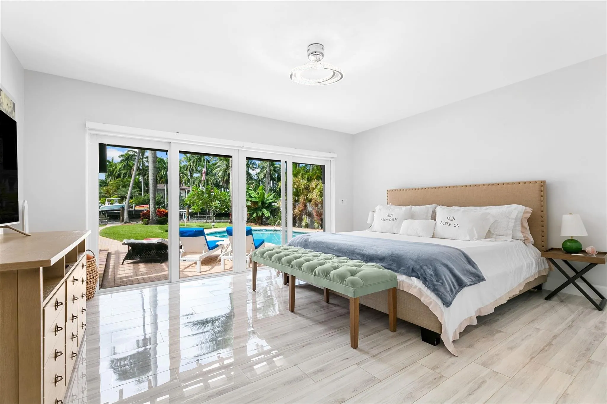 Bedroom featuring large format tile flooring and a light fixture
