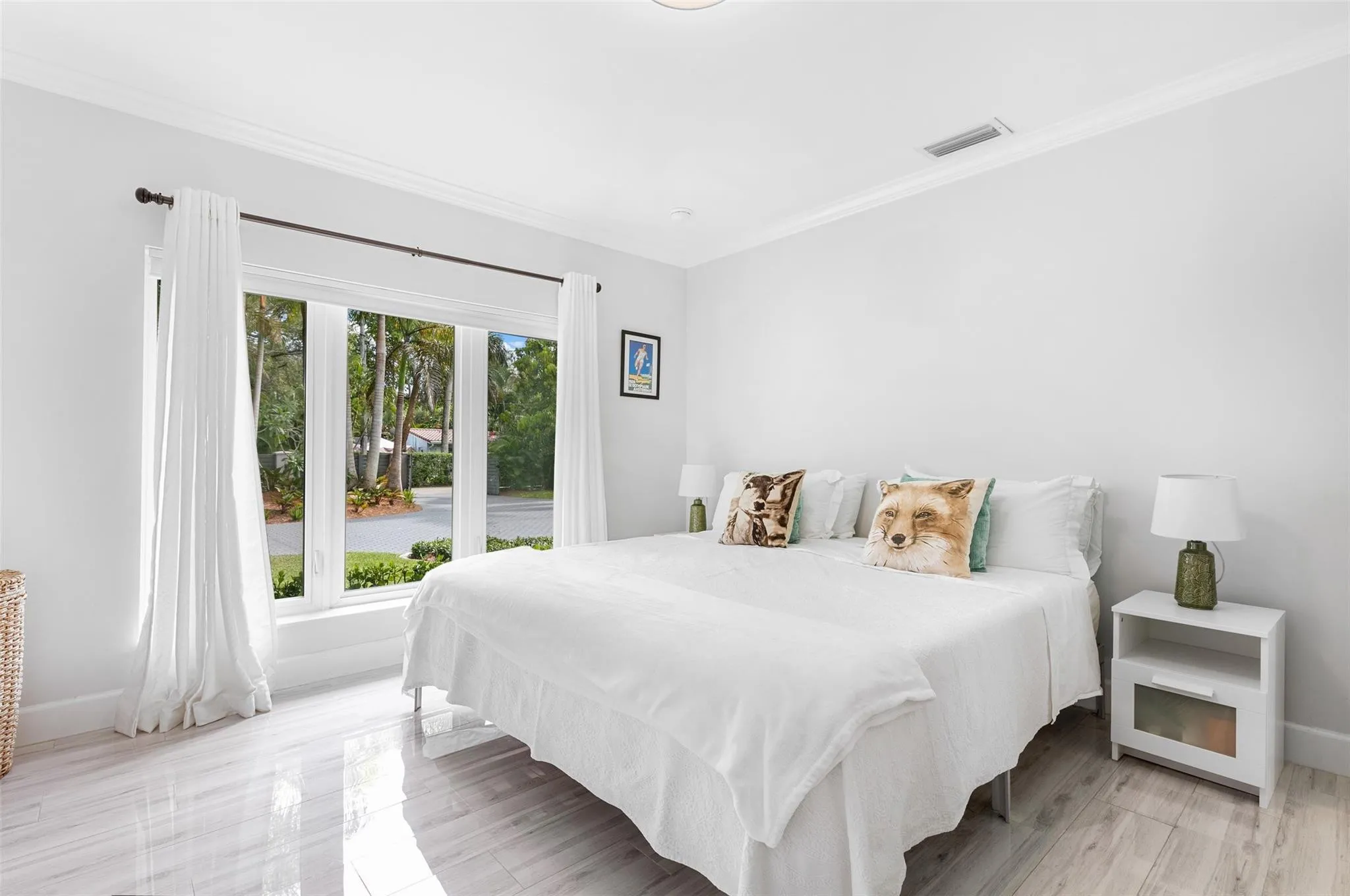 Bright interior with crown molding, wood-finish flooring, a multi-pane window, and a built-in ceiling light