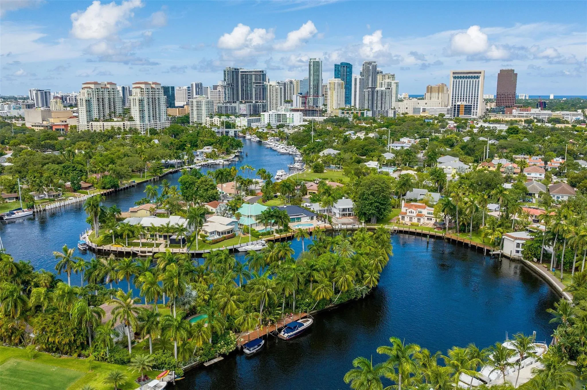 Aerial perspective showcasing a canal-front property amidst tropical landscaping