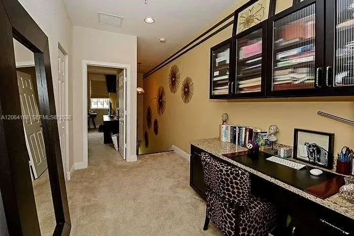 Work space/homework area with built in desk and cabinets.