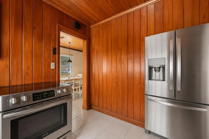 Kitchen area featuring warm wood paneling and a coordinating wood-finish ceiling