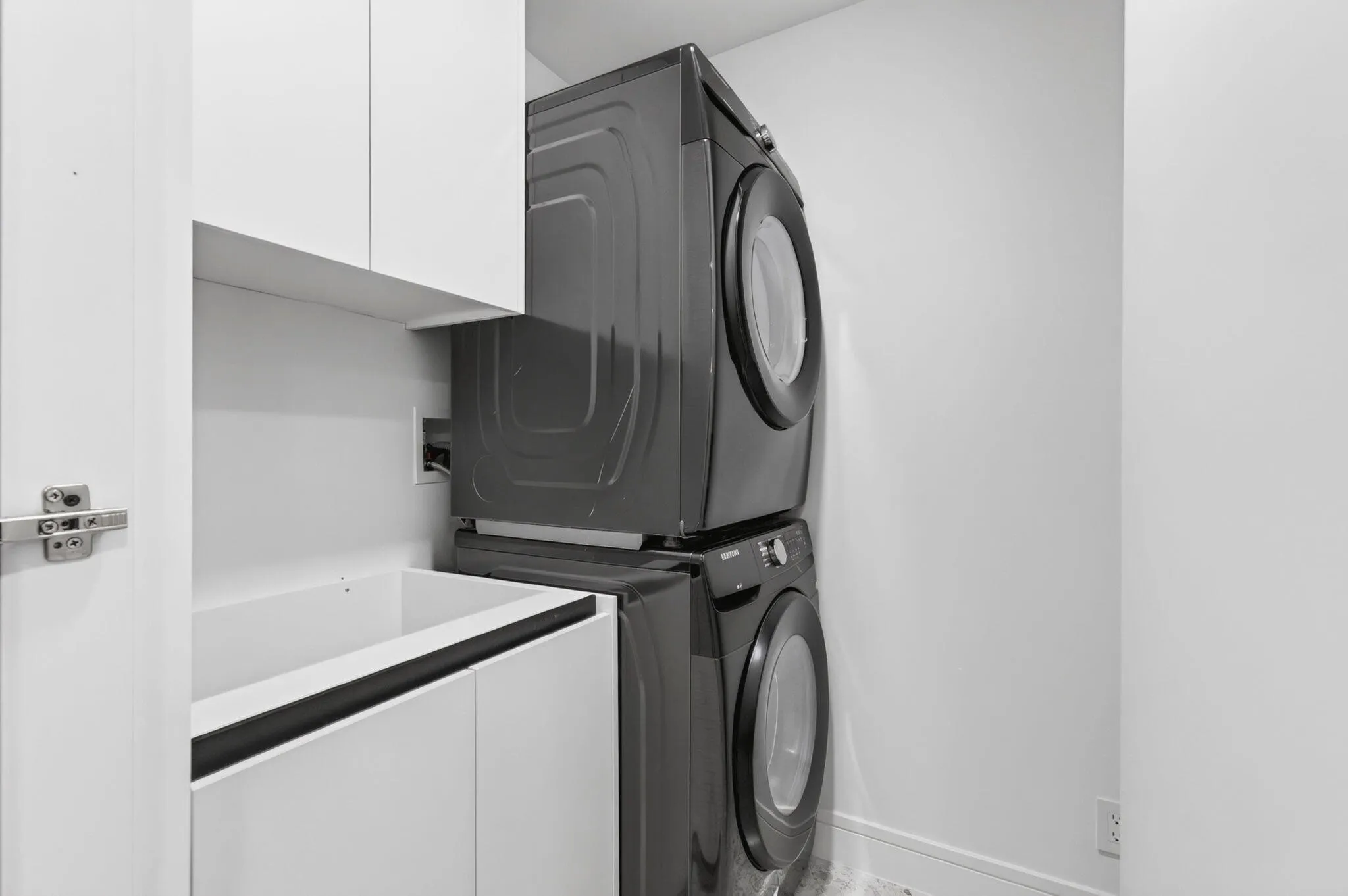 Laundry area behind door in kitchen