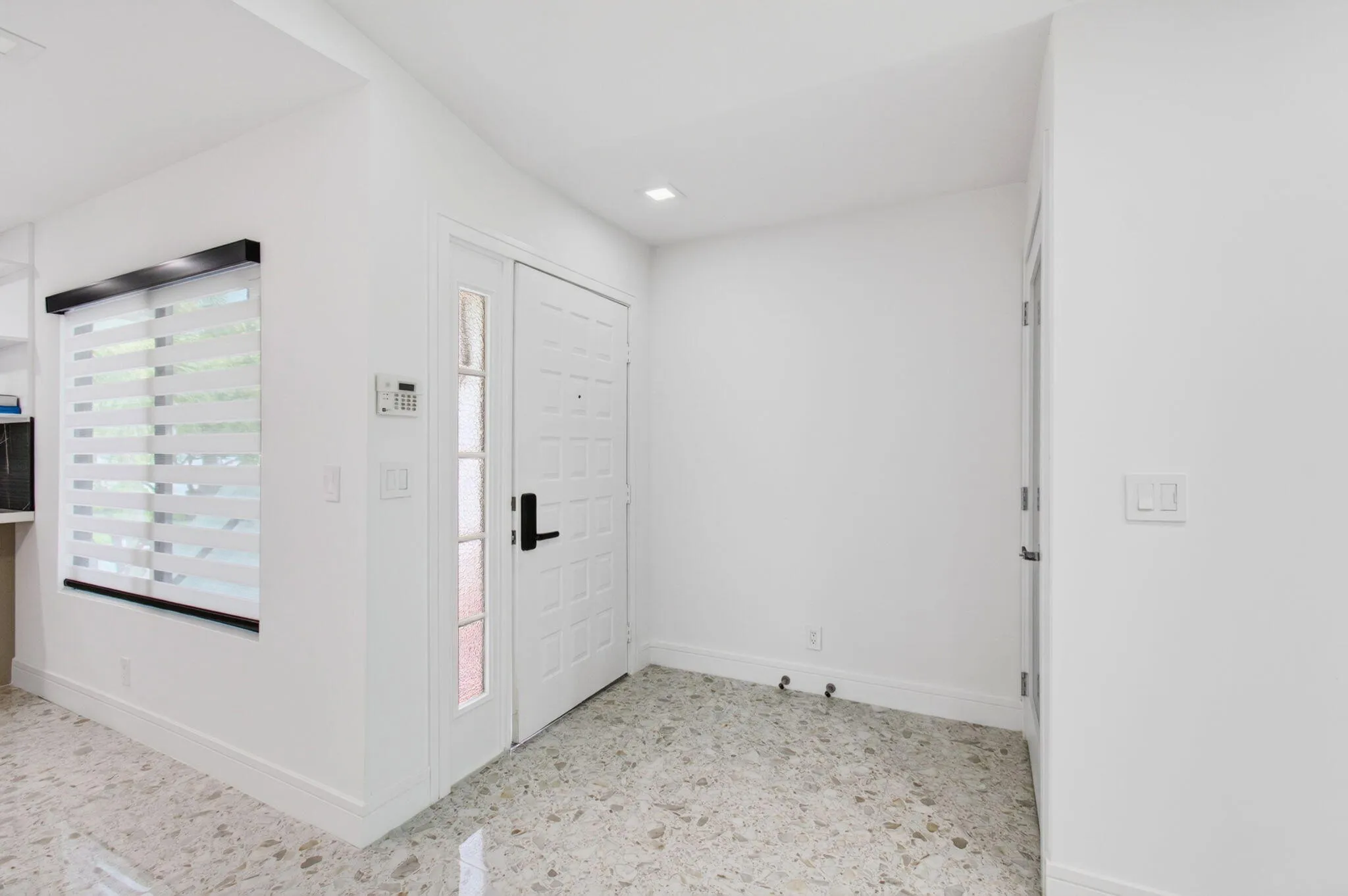 Inside front door on left and closet on right