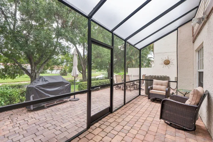 Screened patio featuring a paver flooring with direct access to an outdoor patio