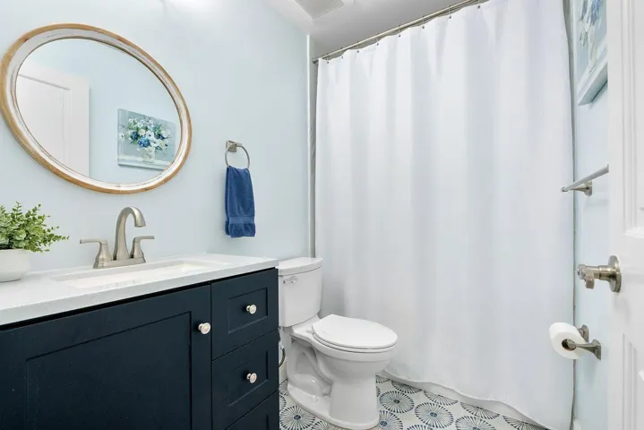 Upstairs Bathroom with upgraded tile with tub and shower combo