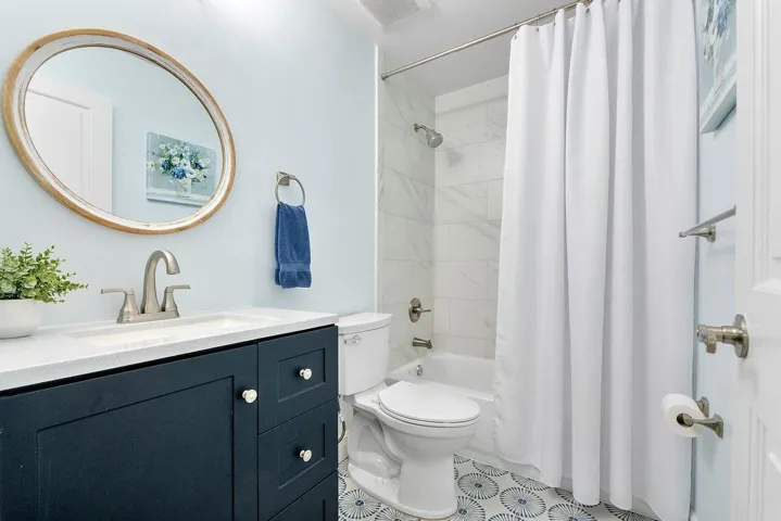 Upstairs Bathroom with upgraded tile with tub and shower combo