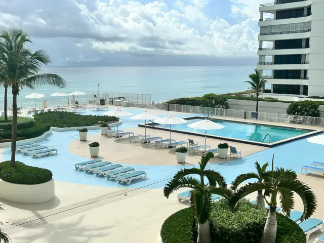 Oceanfront building with large swimming pool and a spacious patio area