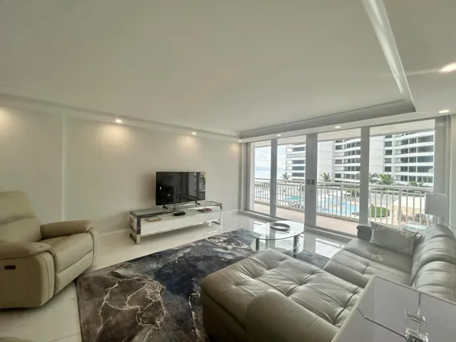 Living area with tile flooring and recessed lighting